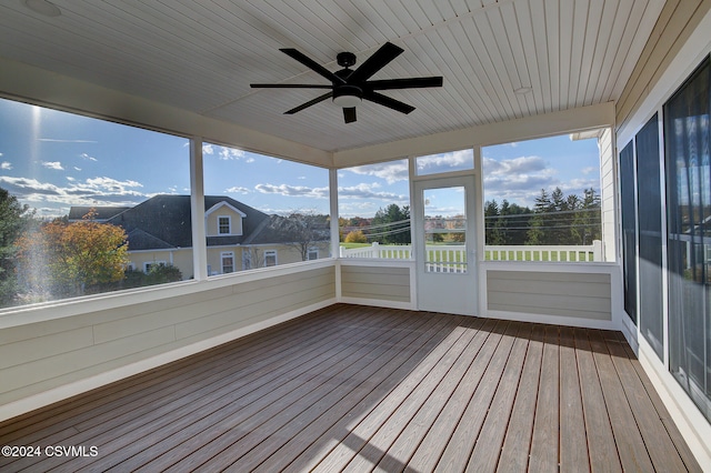 unfurnished sunroom with ceiling fan and a healthy amount of sunlight