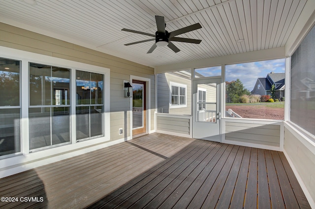 unfurnished sunroom featuring ceiling fan