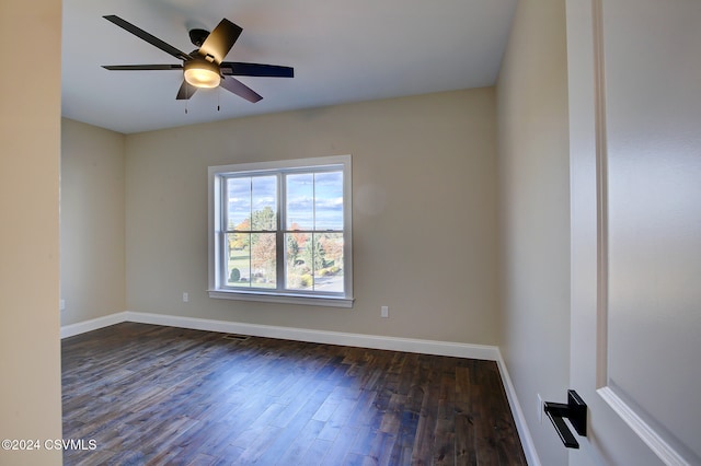 spare room with ceiling fan and dark hardwood / wood-style flooring