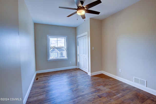 empty room featuring ceiling fan and dark hardwood / wood-style floors