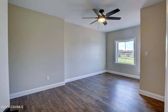 empty room featuring ceiling fan and dark hardwood / wood-style flooring