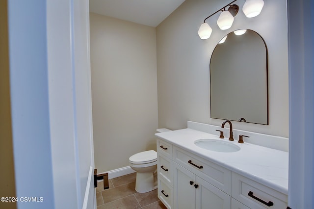 bathroom with vanity, toilet, and tile patterned flooring