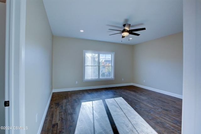 unfurnished room featuring ceiling fan and dark hardwood / wood-style flooring