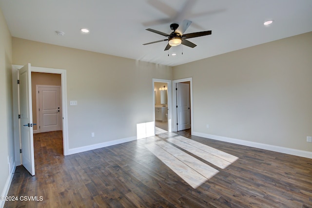 spare room featuring ceiling fan and dark hardwood / wood-style flooring