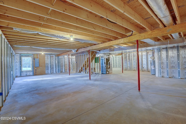 basement featuring water heater, electric panel, and heating unit