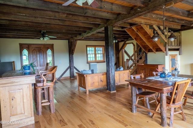 dining area featuring beamed ceiling, wood ceiling, and light hardwood / wood-style flooring