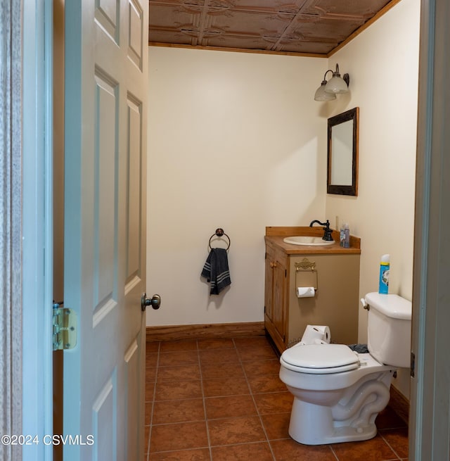 bathroom featuring tile patterned flooring, vanity, and toilet