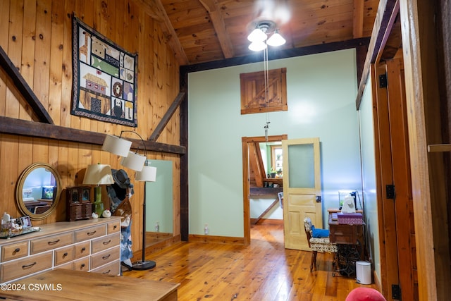 bedroom featuring lofted ceiling with beams, light hardwood / wood-style floors, and wood ceiling