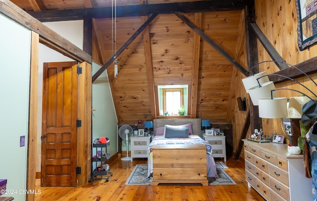 bedroom with vaulted ceiling with beams, light wood-type flooring, and wooden walls