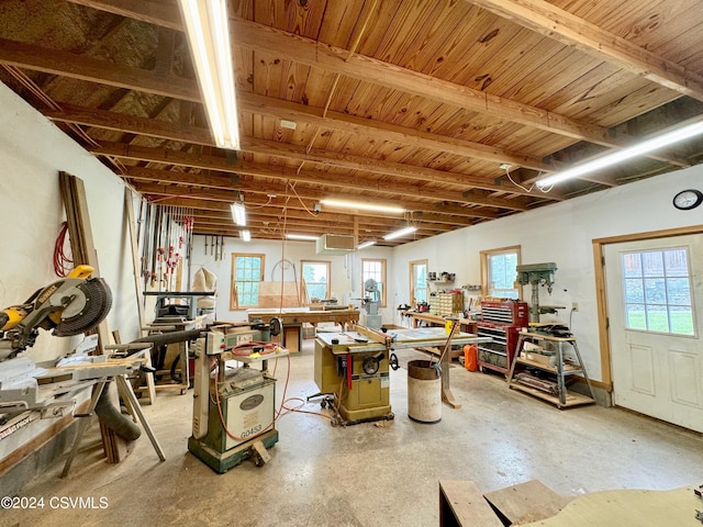 miscellaneous room featuring a workshop area and concrete flooring