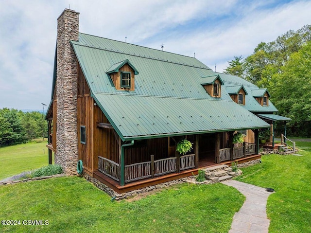 back of property featuring a yard and a porch