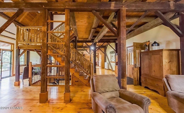 interior space featuring beam ceiling, light wood-type flooring, and wood ceiling