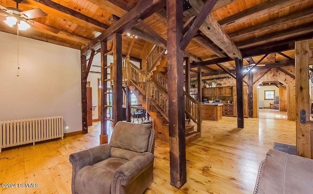 interior space featuring radiator heating unit, wood ceiling, plenty of natural light, and light wood-type flooring