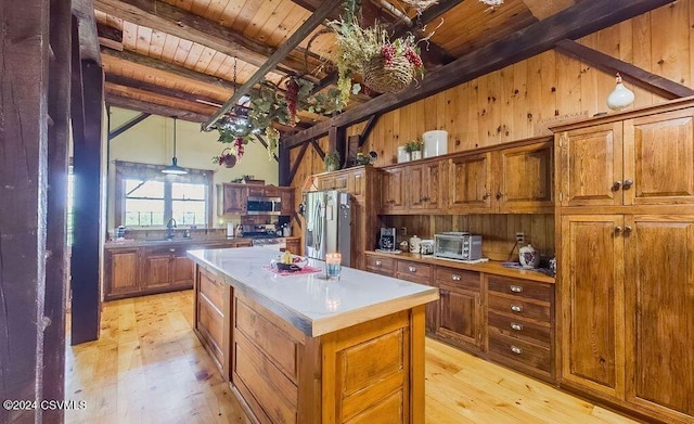 kitchen featuring wood ceiling, stainless steel appliances, sink, light hardwood / wood-style floors, and a kitchen island