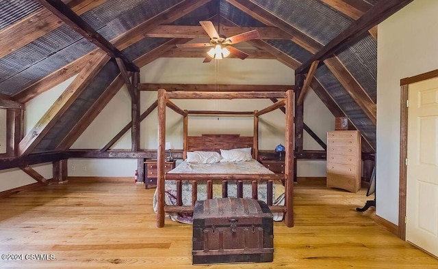 unfurnished bedroom featuring vaulted ceiling with beams, light hardwood / wood-style floors, and ceiling fan