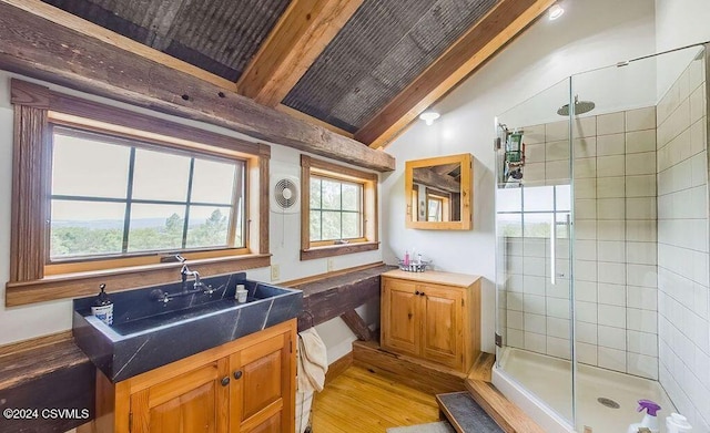 bathroom featuring beam ceiling, vanity, wood-type flooring, and a shower with shower door