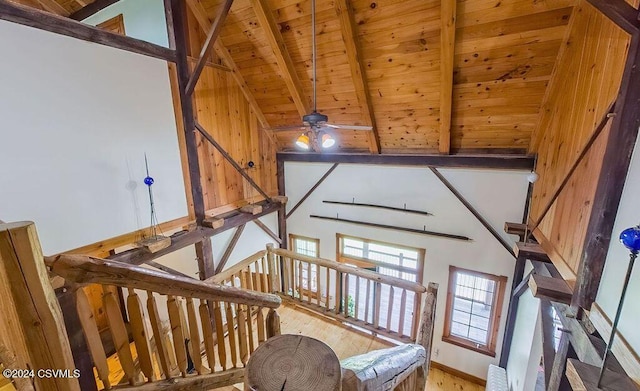 stairway with wooden ceiling, high vaulted ceiling, ceiling fan, beam ceiling, and wood-type flooring