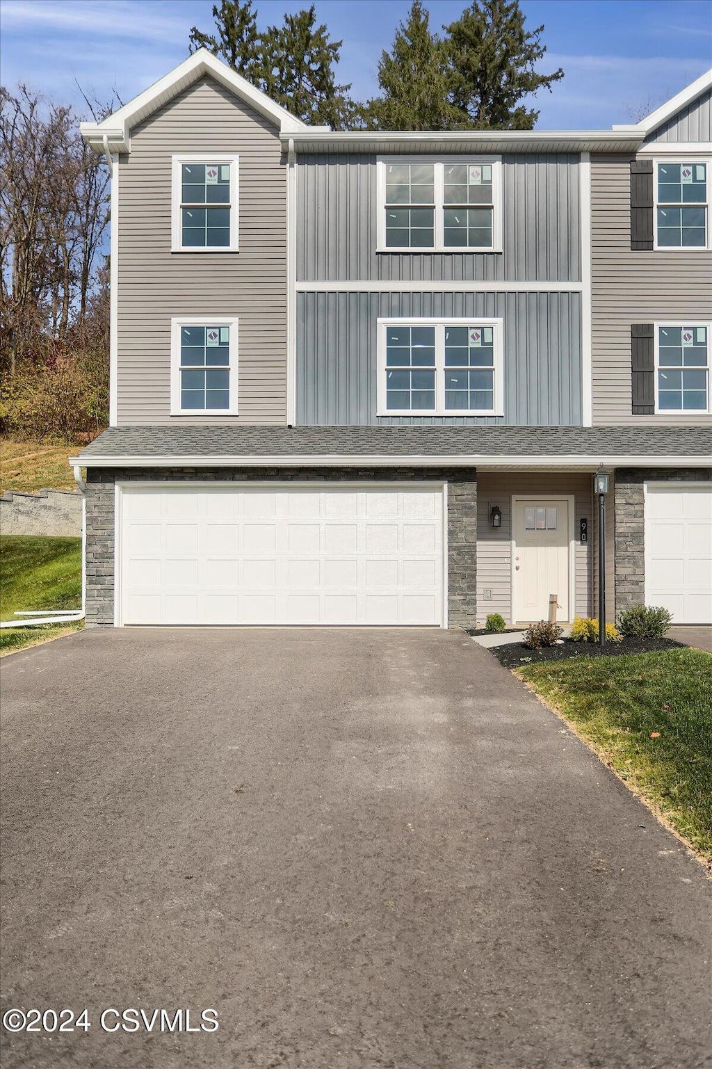 90 Limerick Ln, Selinsgrove, PA 17870 - view of property featuring an attached garage, asphalt driveway, and stone siding