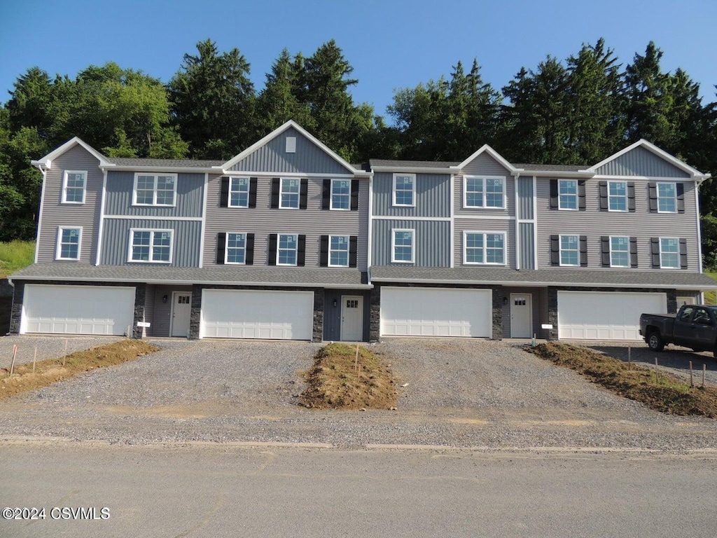 90 Limerick Ln, Selinsgrove, PA 17870 - view of property featuring gravel driveway, a garage, and stone siding