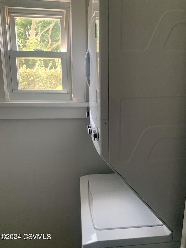 laundry room featuring stacked washer and dryer