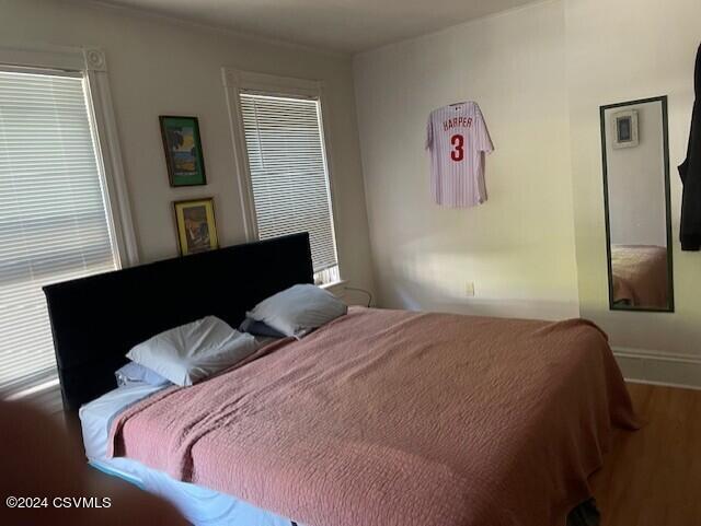 bedroom with wood finished floors