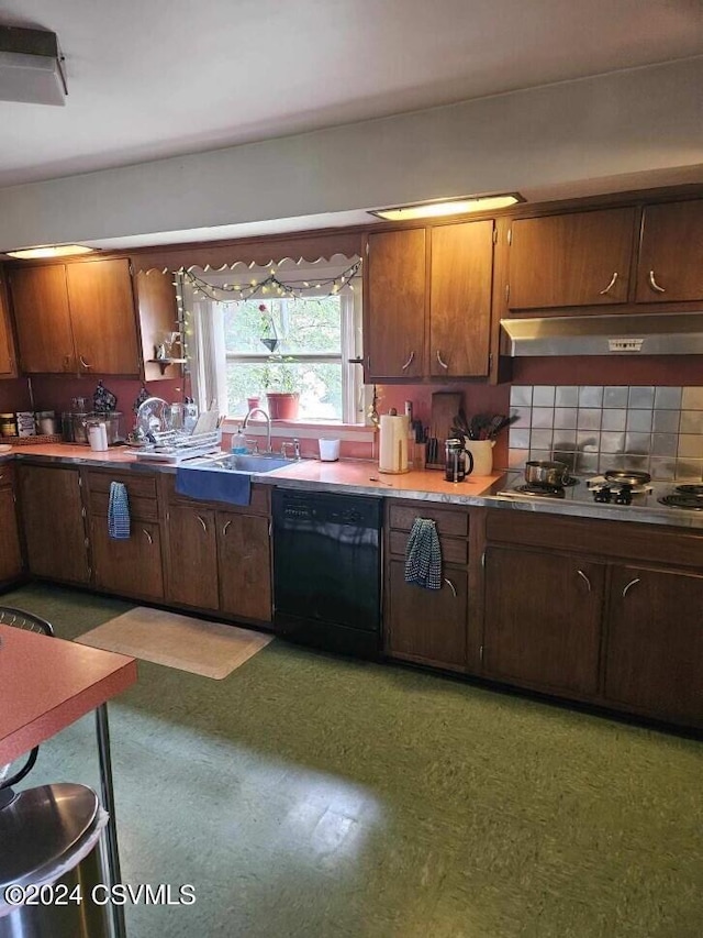 kitchen with tile patterned floors, black appliances, under cabinet range hood, a sink, and backsplash