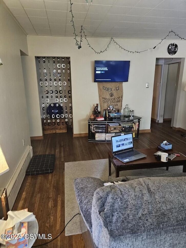 living room with baseboards and wood finished floors