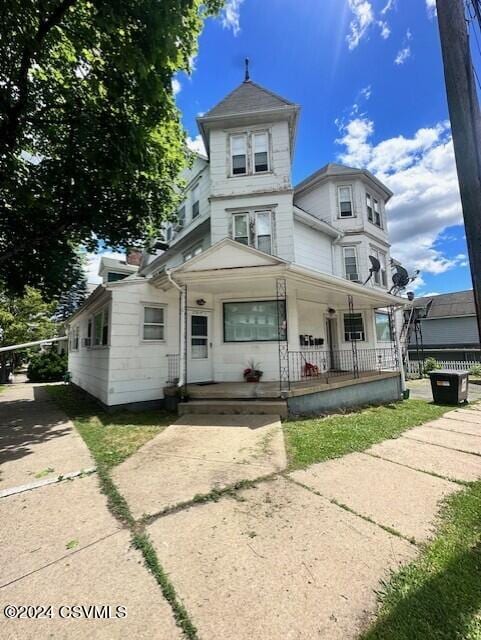 victorian-style house featuring covered porch