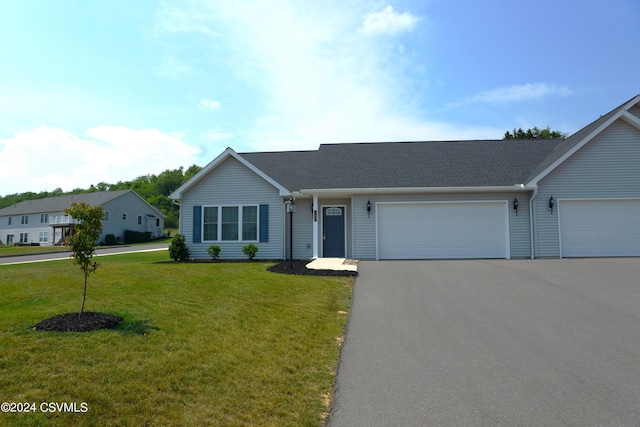 single story home with an attached garage, driveway, and a front lawn