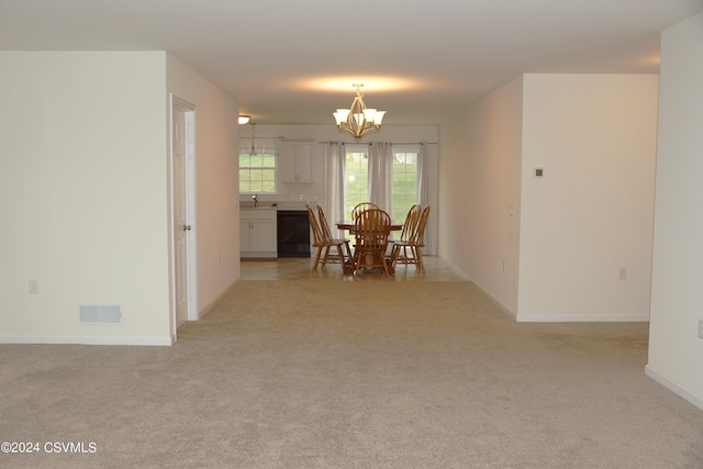 dining room with a chandelier, visible vents, light carpet, and baseboards