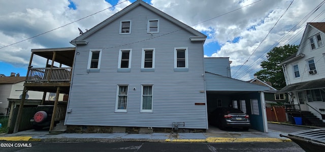 view of front of house featuring a carport and a balcony