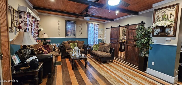 living room featuring ceiling fan, light hardwood / wood-style floors, crown molding, a barn door, and wooden ceiling