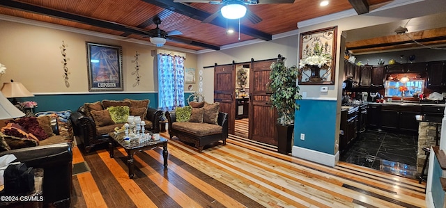 living room with a barn door, ceiling fan, light hardwood / wood-style flooring, and wooden ceiling