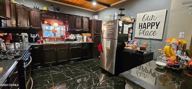 kitchen featuring dark brown cabinetry, sink, dark tile flooring, and appliances with stainless steel finishes