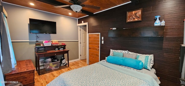 bedroom with ceiling fan, ornamental molding, hardwood / wood-style flooring, and wood ceiling