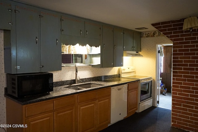 kitchen featuring dark stone countertops, range with electric cooktop, sink, and white dishwasher