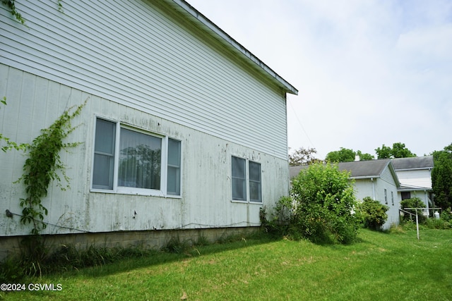 view of side of home featuring a yard