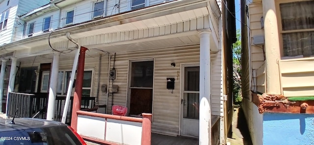 entrance to property featuring a porch