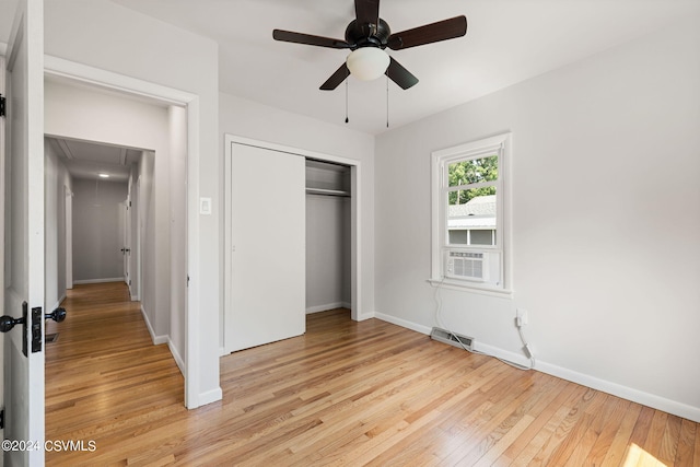 unfurnished bedroom with a closet, light hardwood / wood-style flooring, ceiling fan, and cooling unit