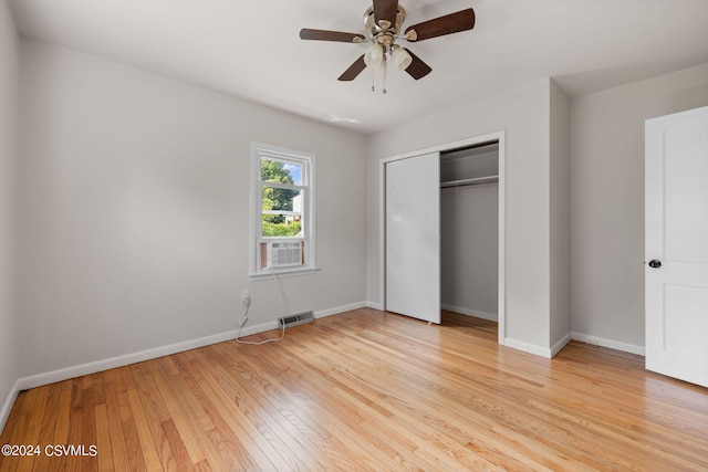 unfurnished bedroom with ceiling fan, light hardwood / wood-style floors, and a closet