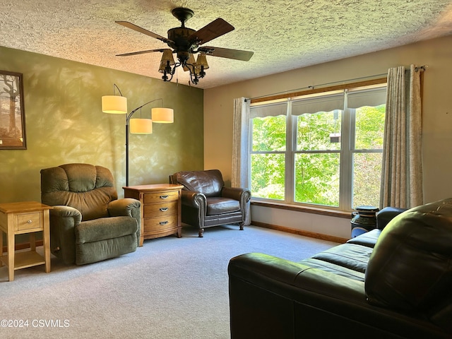 carpeted living room with ceiling fan and a textured ceiling