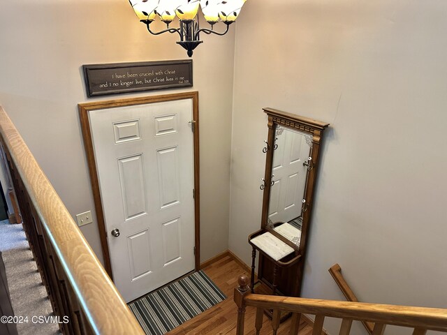 entrance foyer with hardwood / wood-style flooring and a chandelier