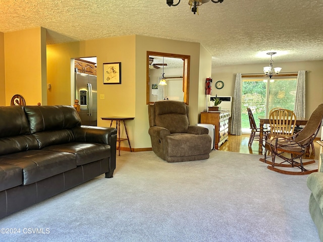 living room featuring a notable chandelier, light carpet, and a textured ceiling