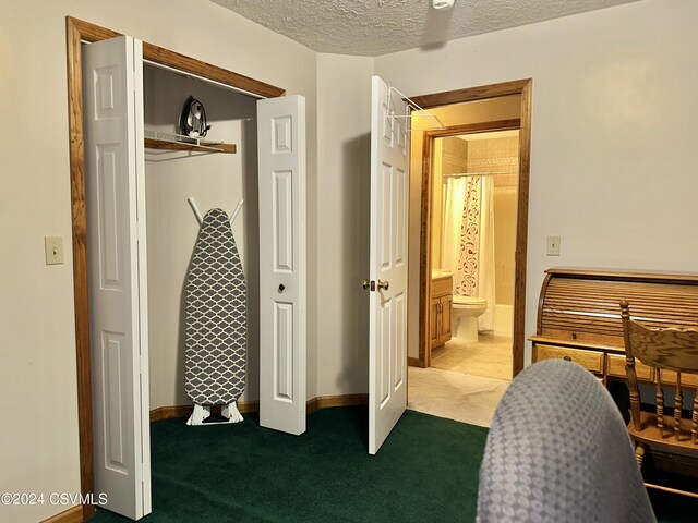 carpeted home office with a textured ceiling