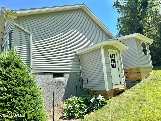 view of side of home featuring a yard