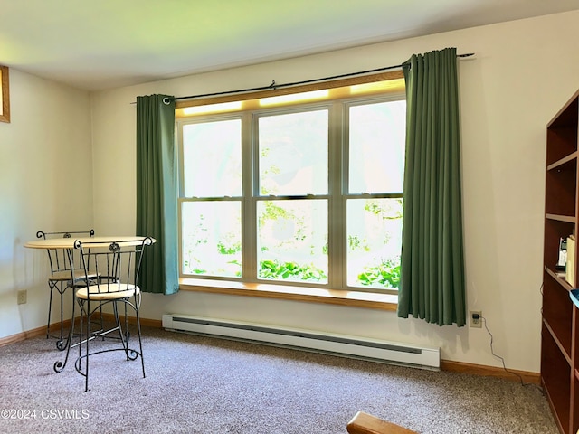 interior space featuring a baseboard heating unit and carpet floors