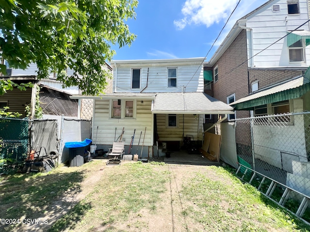 rear view of property with a yard