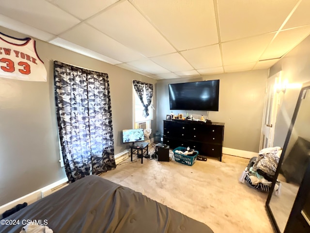 living room featuring carpet flooring and a drop ceiling