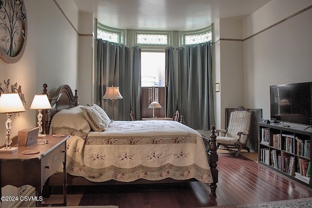 bedroom with dark wood-type flooring