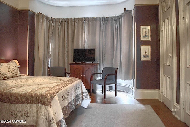 bedroom with hardwood / wood-style flooring